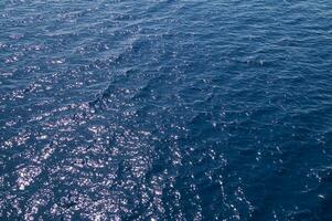 an aerial view of the ocean with a boat in the water photo