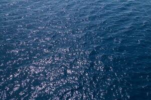 an aerial view of the ocean with a boat in the water photo