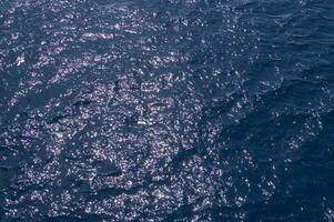 an aerial view of the ocean with a boat in the water photo