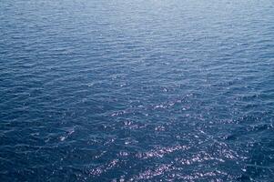 an aerial view of the ocean with a boat in the water photo