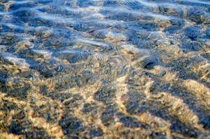 the water is clear and blue with sand photo
