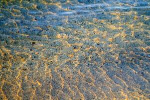 the water is clear and blue with sand photo