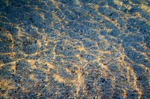 the water is clear and blue with sand photo