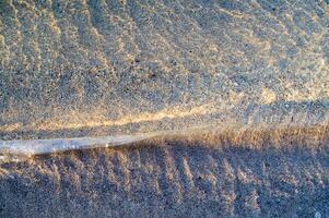 the water is clear and blue with sand photo