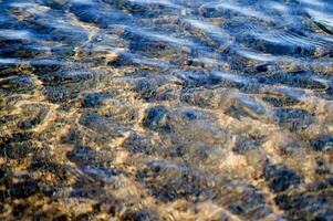 the water is clear and blue with sand photo