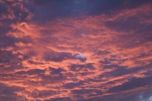 a red and orange sky with clouds photo