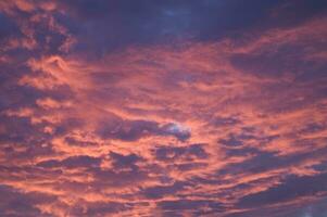 a red and orange sky with clouds photo