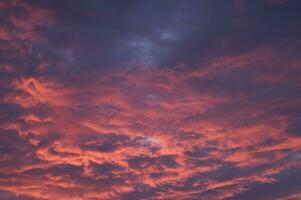 a red and orange sky with clouds photo