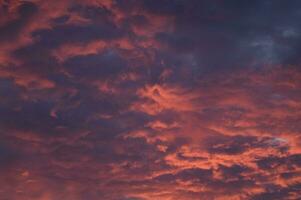 a red and orange sky with clouds photo