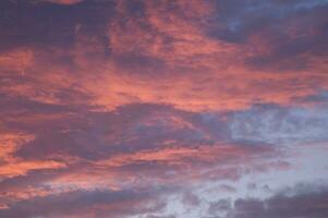 a red and orange sky with clouds photo