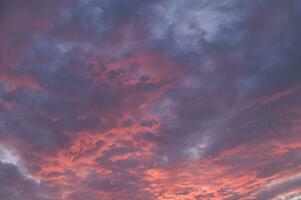 a red and orange sky with clouds photo