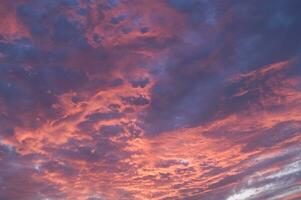 a red and orange sky with clouds photo