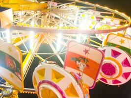 view of a funfair at night photo