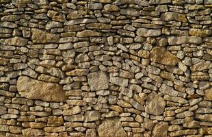 a stone wall with many different types of rocks photo