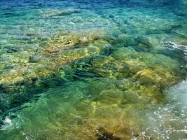 a rocky shore with waves crashing against the rocks photo