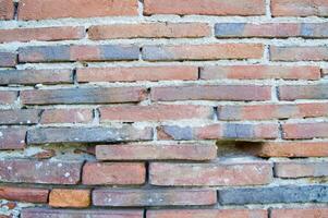 an old brick wall with a hole in it photo