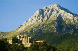 a mountain range with a few houses on top photo