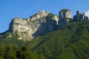 a mountain range with a few houses on top photo