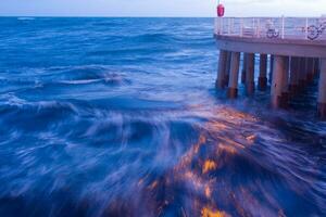 a pier with lights on at night photo