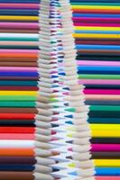 many colored pencils are arranged in a row photo