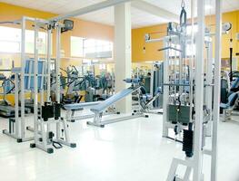 a row of dumbbells on a rack in a gym photo