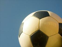 a close up of a soccer ball with leather photo