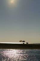 a boat is in the water at sunset photo