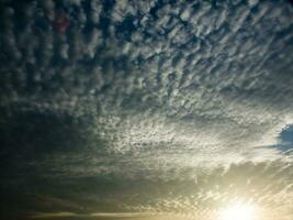 a view of the sky with clouds and sun photo