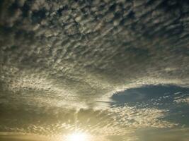 a view of the sky with clouds and sun photo