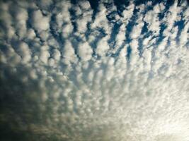 a view of the sky with clouds and sun photo