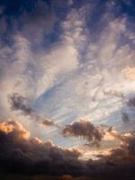 a jet plane flying through a cloudy sky photo