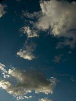 a jet plane flying through a cloudy sky photo