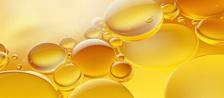 Abstract background banner with various yellow bubbles of oil or serum, providing copy space. Represents photo