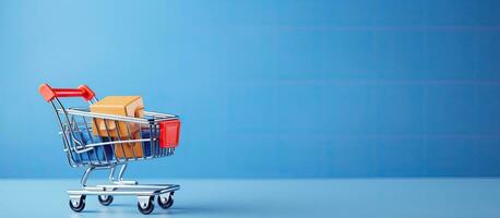 toy shopping cart with boxes on a blue background. There is space available for text or design. photo