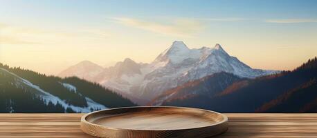 Vintage style concept where wooden plate on a table with a blurry mountain background, providing photo