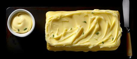 Butter on artisan paper, dairy farm goods, black background, top view, with empty space for text photo