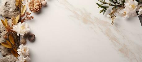 Top view of a flat lay mock-up with a dry natural grass, leaves, and flowers frame on a white marble photo