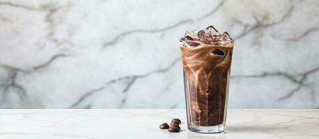 iced cocoa in a clear glass on a marble surface with space for your text photo