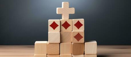 Wooden cube blocks stacked in a plus sign shape represents added value, benefits, and additional photo