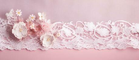 A close-up photograph of a beautiful white lace cloth on a pink background. detailed floral pattern photo