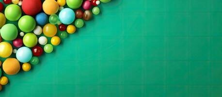 Vertical banner with copy space showcasing vibrant candy balls on a green paper background. photo