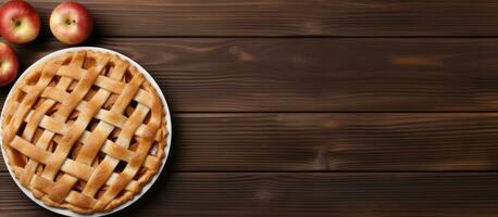 Classic apple pie with space for text on a wooden table, arranged in a flat lay. Perfect for photo