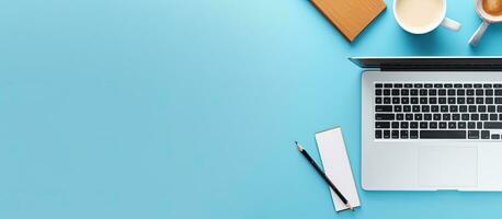 A creative flat lay photo of a workspace desk showing a top view office desk with a laptop,