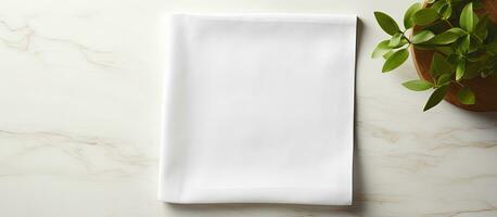 Top perspective of a white kitchen napkin isolated on a table background, with no objects present. photo