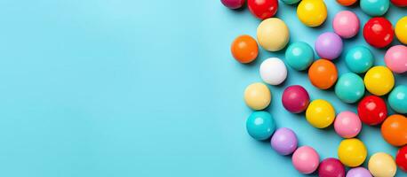 Colorful candy balls are displayed on a blue paper background in the format of a horizontal photo