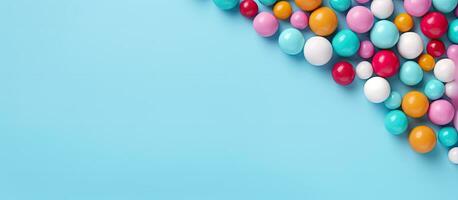 Colorful candy balls are displayed on a blue paper background in the format of a horizontal photo