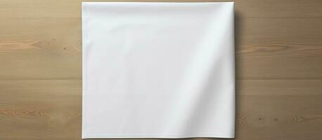 Top perspective of a white kitchen napkin isolated on a table background, with no objects present. photo