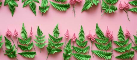 Green fern leaves crocheted on a pink background with room for text. This design features a photo