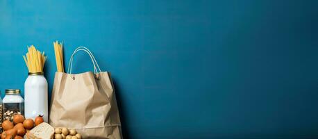 A blue background with copy space featuring a paper bag containing essential food items such photo