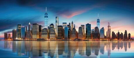 The Manhattan downtown skyline in New York City is illuminated with skyscrapers at sunset, creating photo